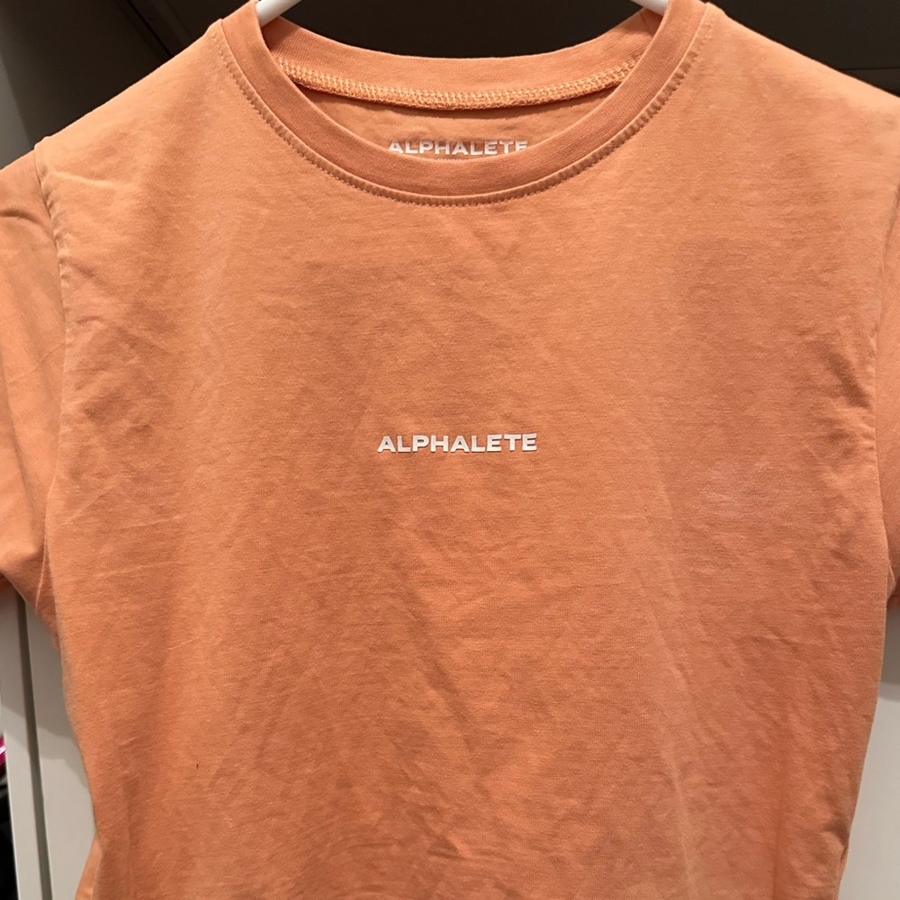 Alphalete orange shirt. Athletic wear. Size XS.